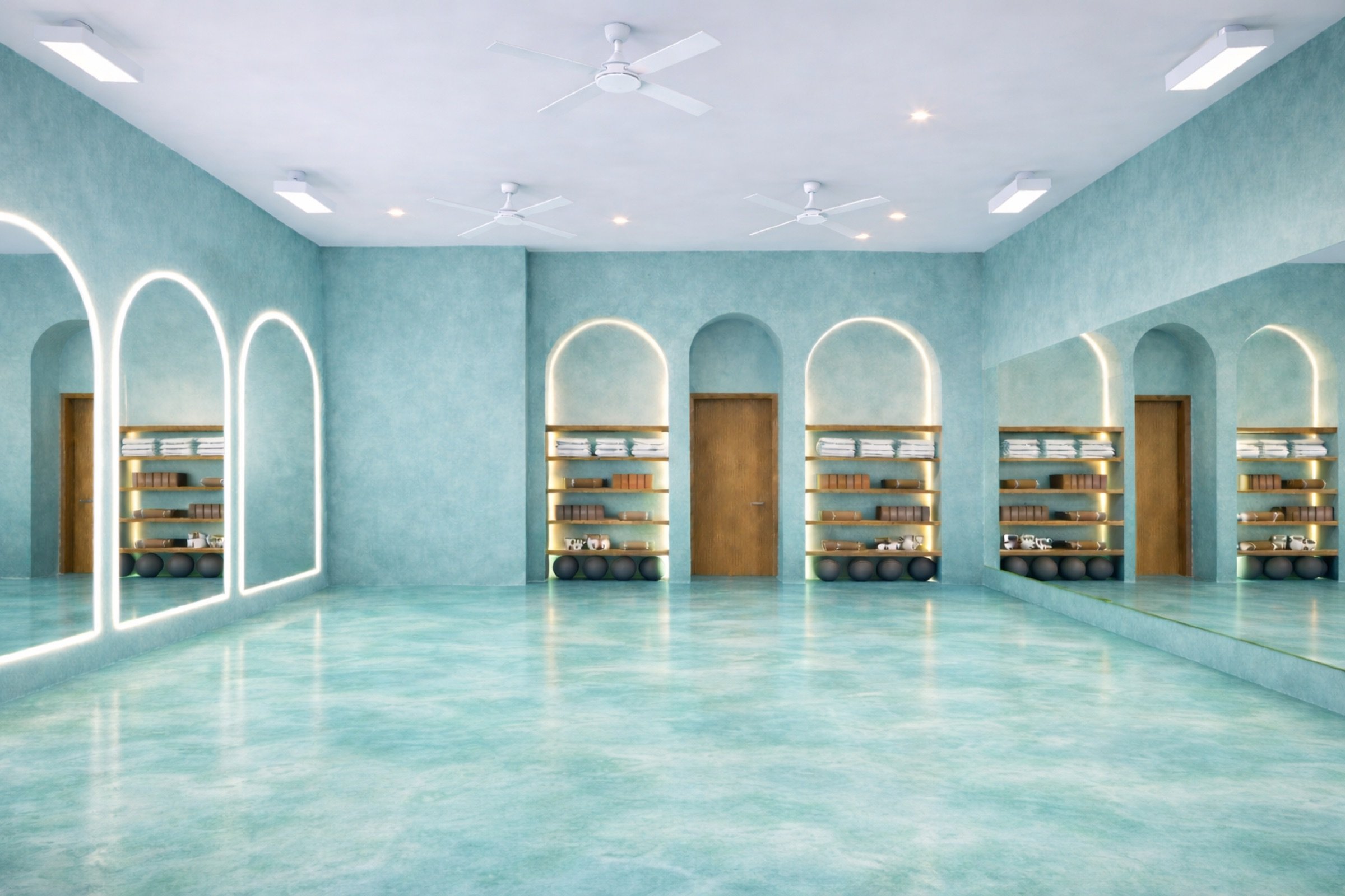 Mimi Yoga and Pilates Aventura studio with teal walls and illuminated arches