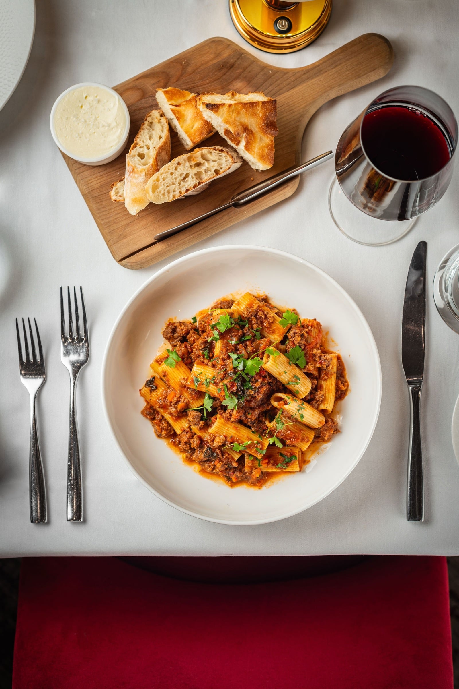 Rigatoni bolognese with bread and red wine at Rao's Miami Beach