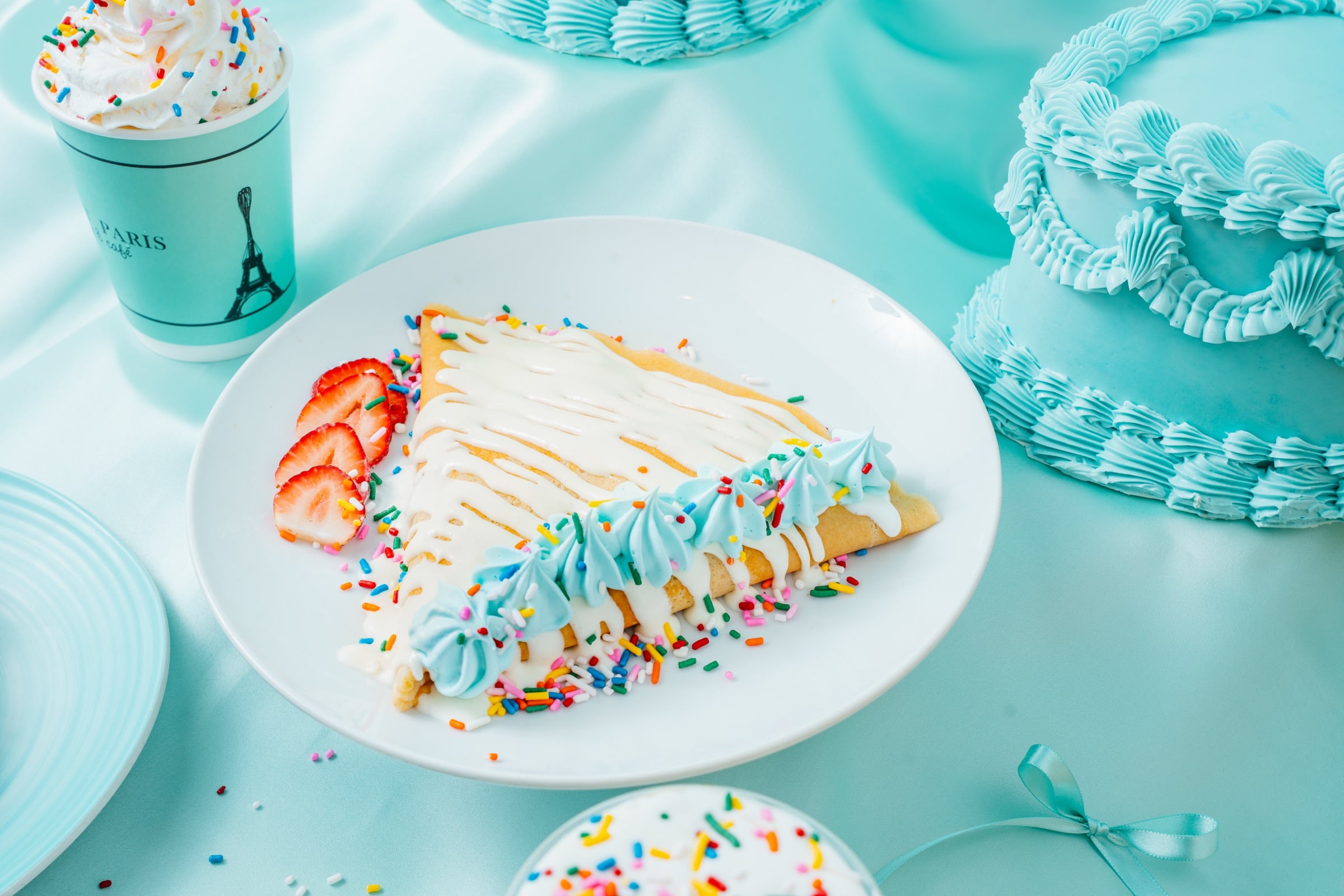 Sweet Paris funfetti birthday crêpe layered with sweet cream and strawberries