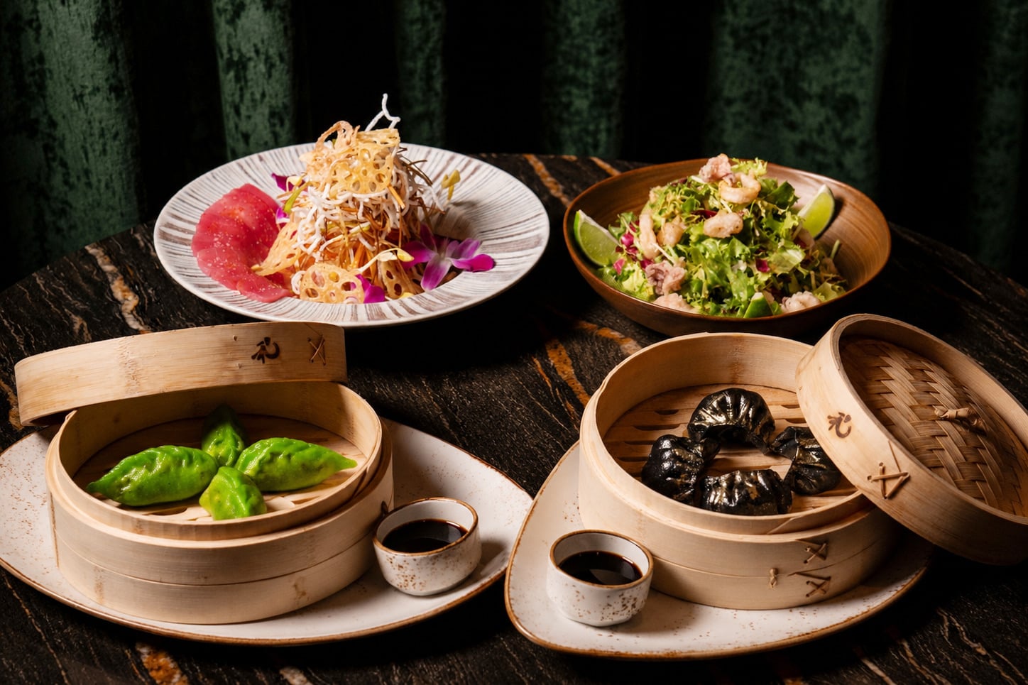 Shareable spread of crispy spinach, Singapore 17 vegetable salad, and black and gold cod dumplings at China Grill Bal Harbour