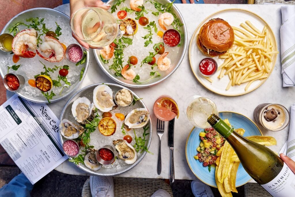 Seafood spread, burger, and wine at News Cafe