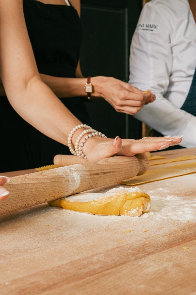Rolling fresh pasta dough at a Donna Mare pasta-making class