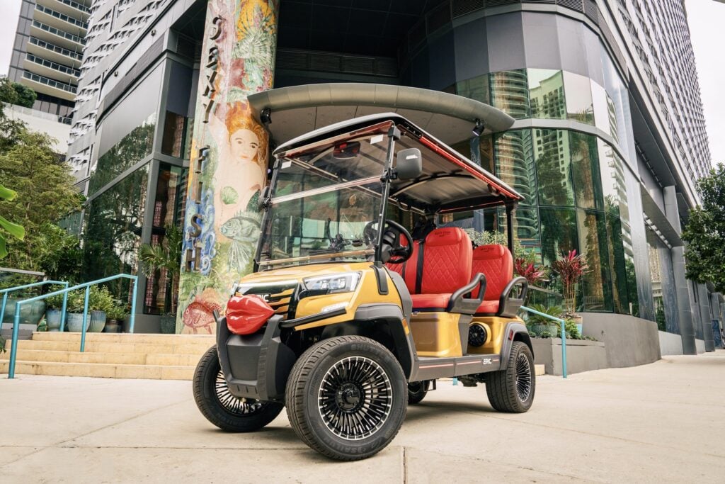 Sexy Fish Miami's gold golf cart parked outside the restaurant in Brickell