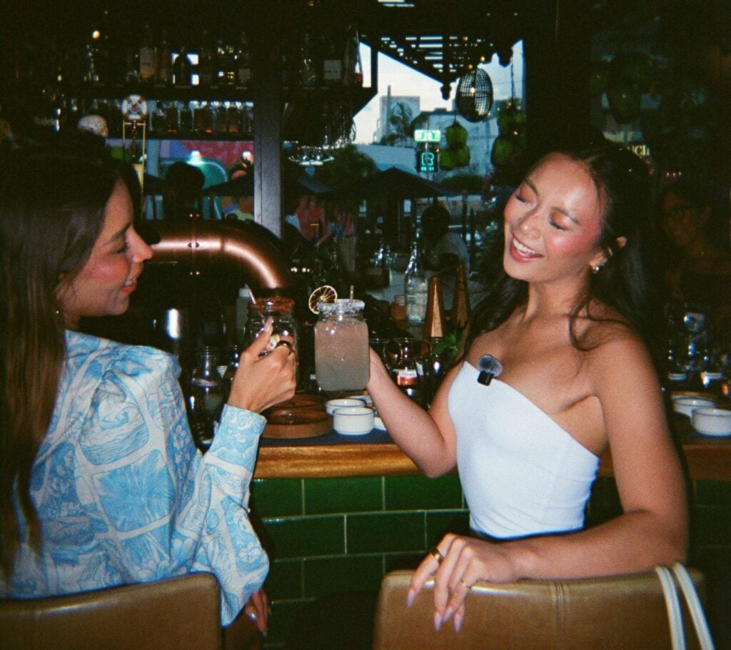 Two guests toasting margaritas at the bar during Agave Social at Bakan in Wynwood