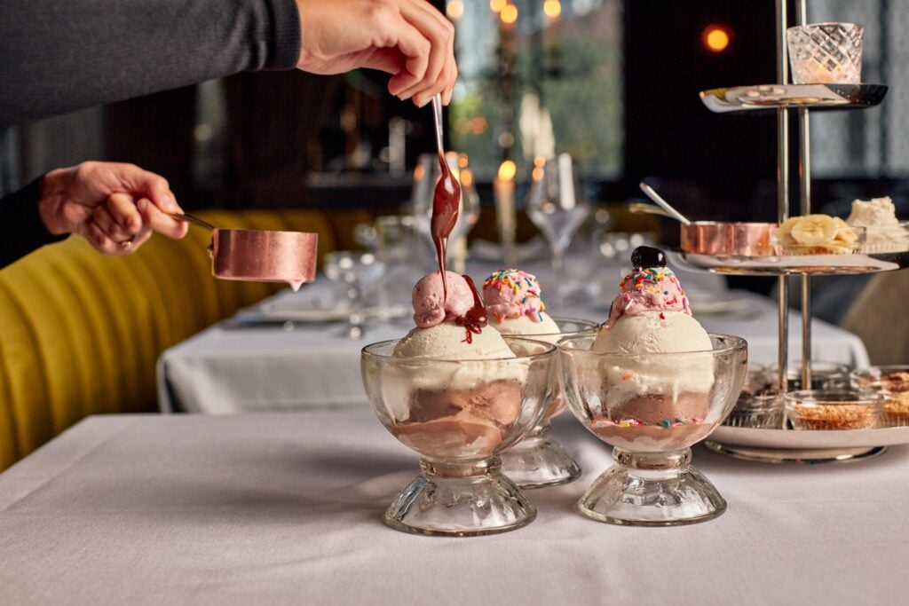 Ice cream sundaes finished tableside with hot fudge at Maple & Ash