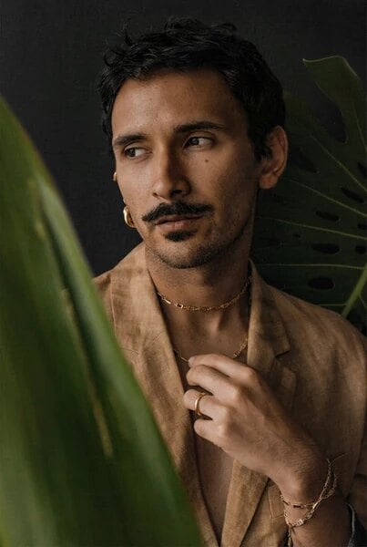 Guatemalan jewelry designer Edgar Navarro, whose namesake line is sold at The One Who Travels, wearing a gold hoop earring and chain