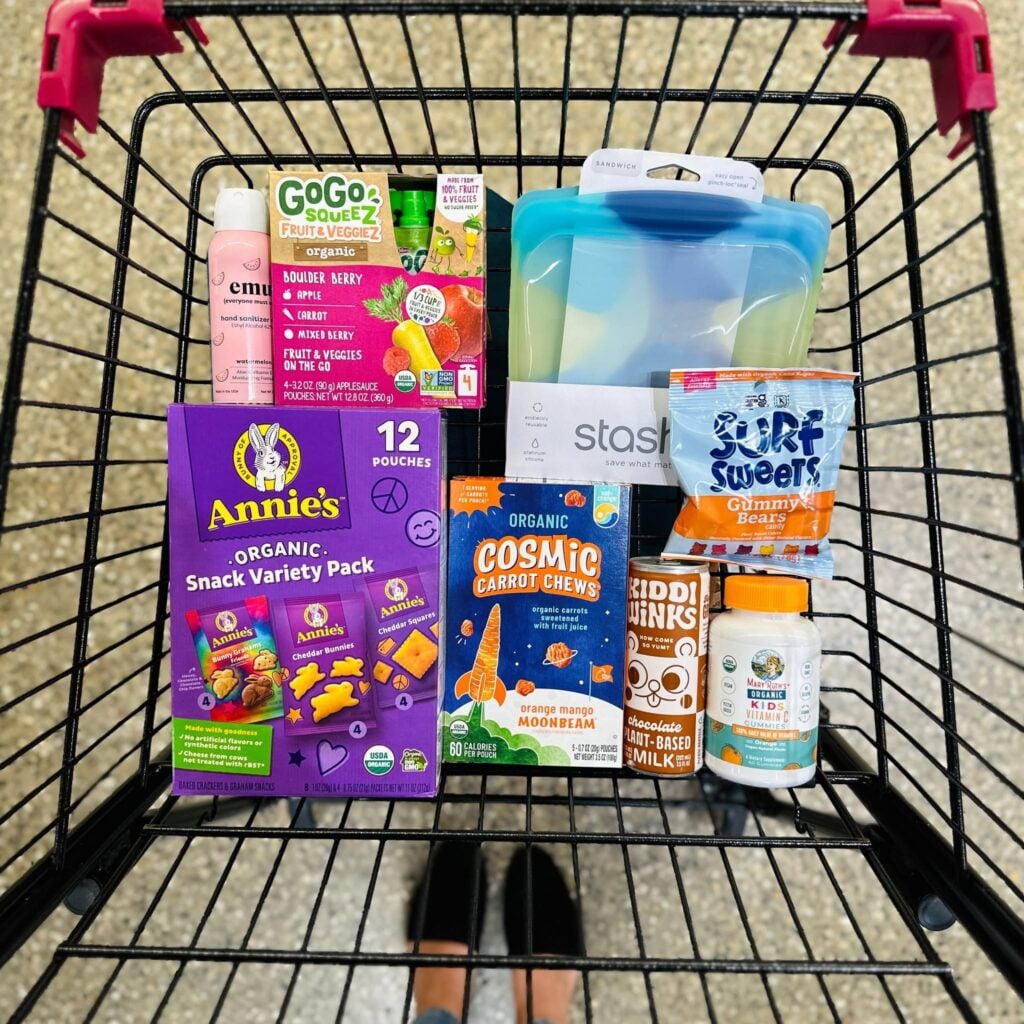 A shopping cart filled with back-to-school snacks and lunchbox staples at Plum Market Aventura