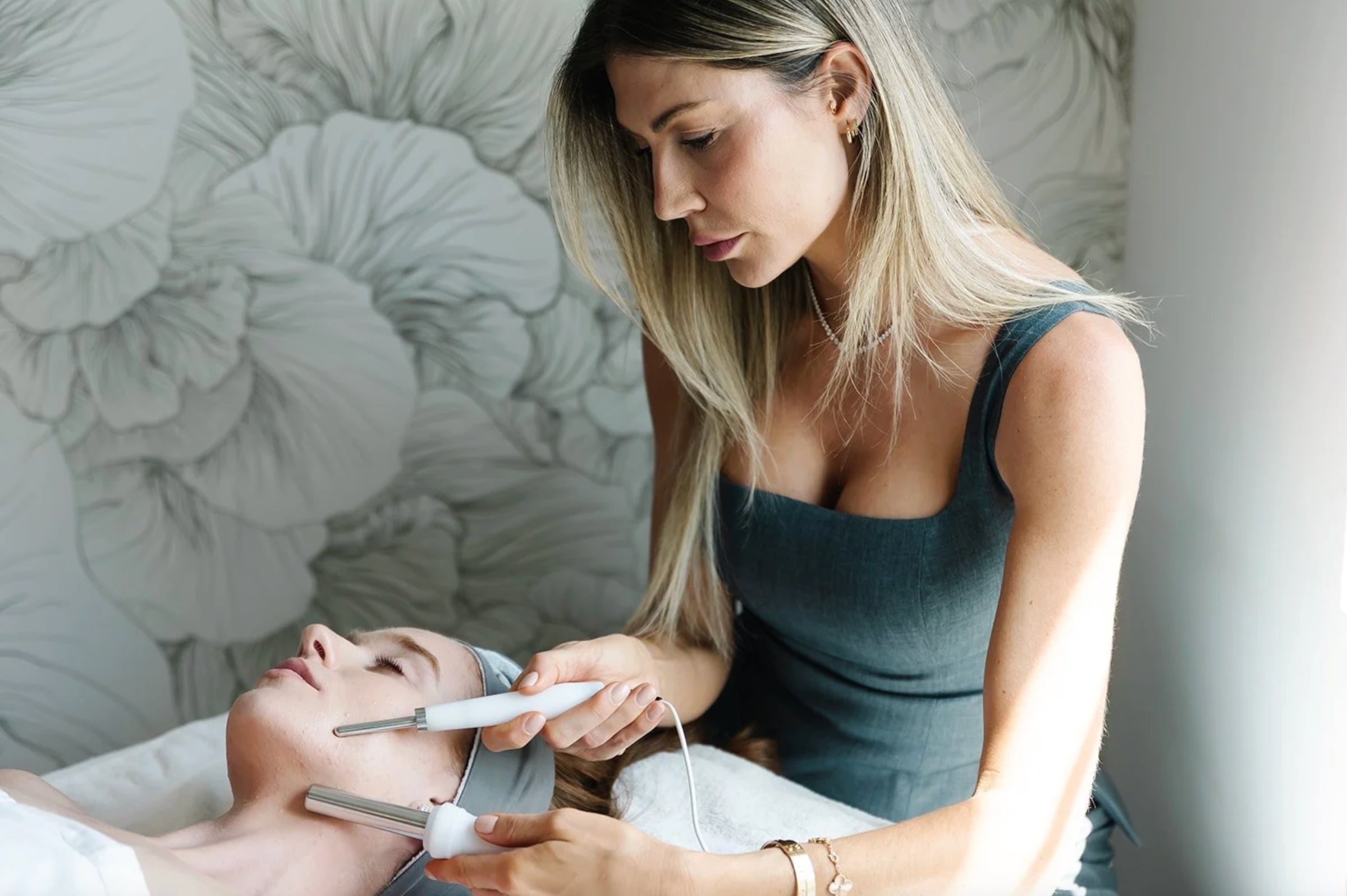 A provider performing a device-based facial treatment on a client at Skincare by Amy Peterson in Miami Beach