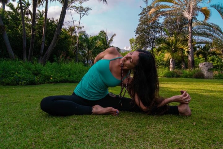 Woman practicing gentle vinyasa yoga in the Miami Beach Botanical Garden