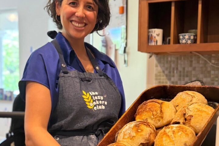 Laura Rodriguez-Costacamps holding freshly baked sourdough loaves