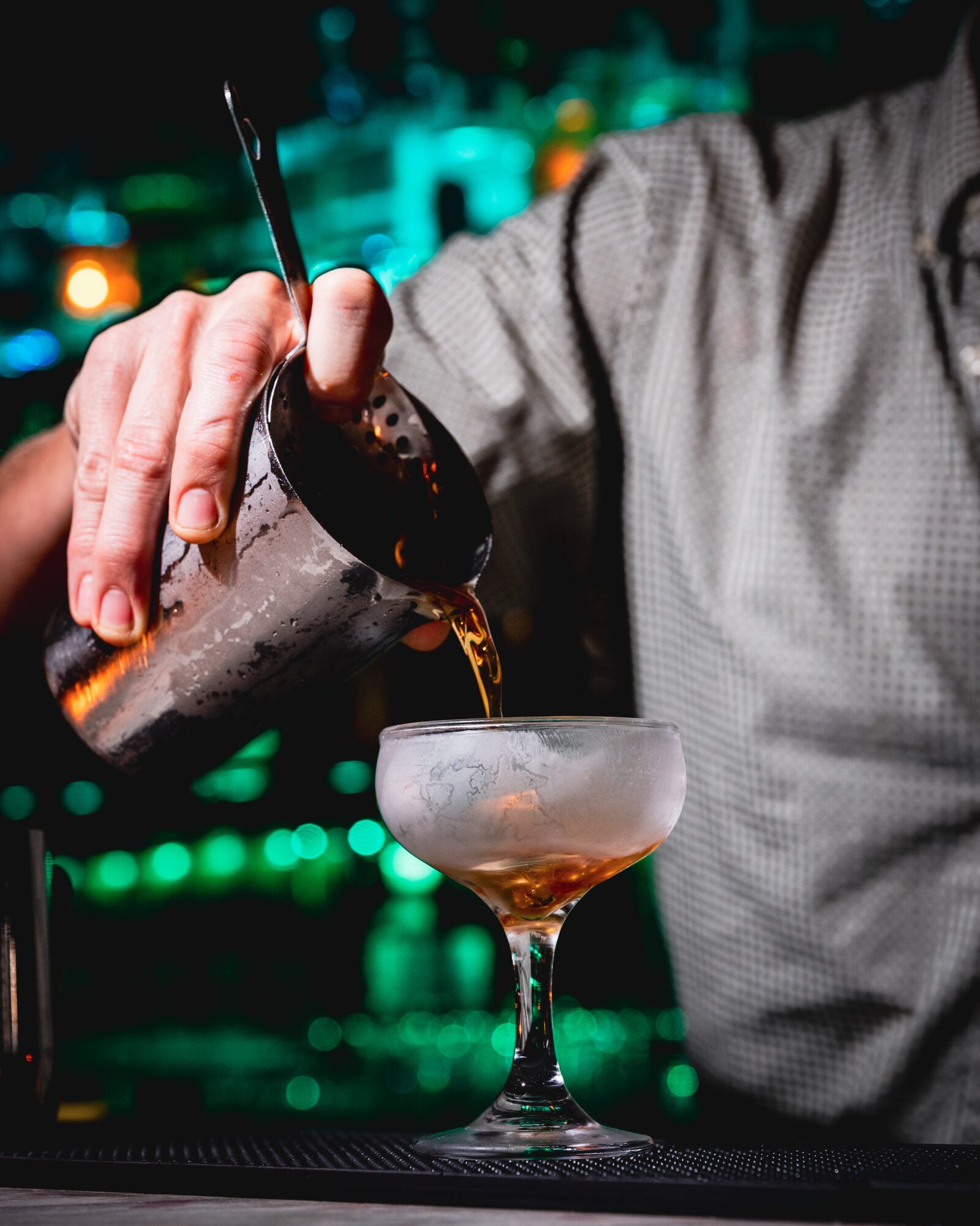 A bartender pouring a cocktail at The Scapegoat Miami