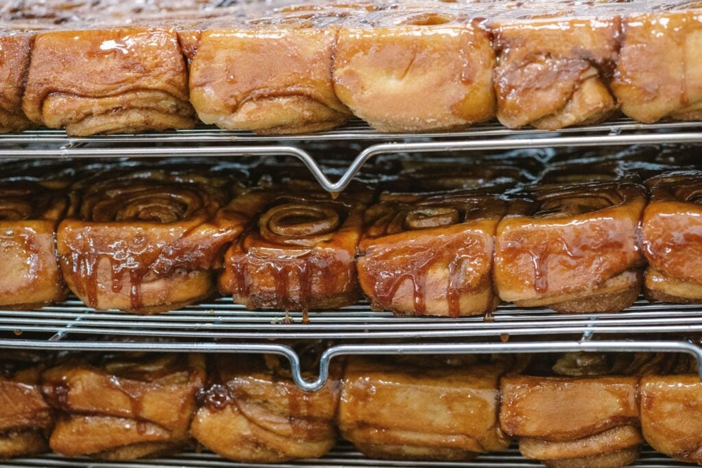 Trays of cinnamon rolls cooling on racks at Knaus Berry Farm